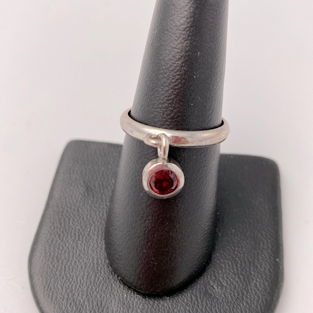 Sterling silver garnet charm ring. Stamped 925. Size 8.5